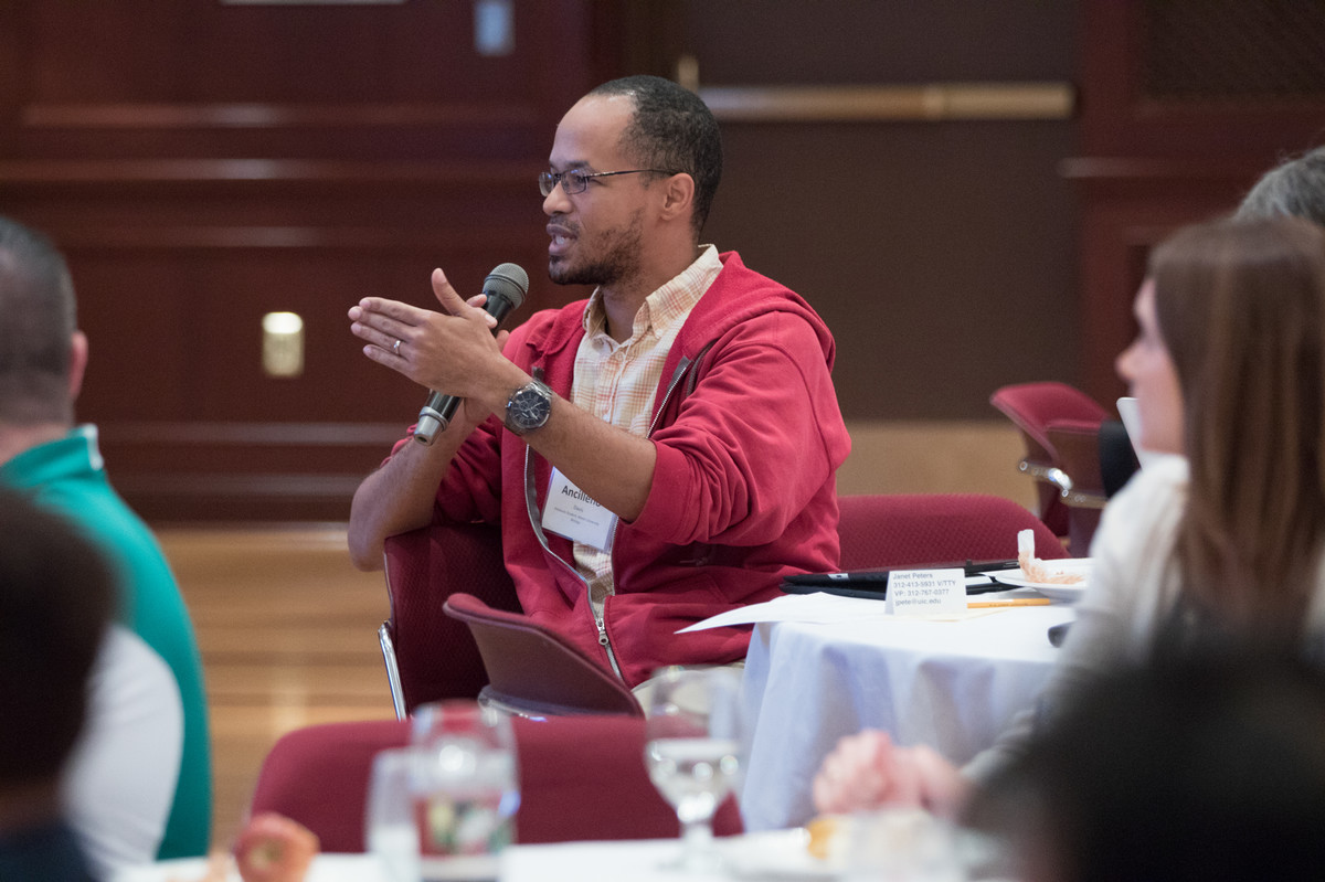 A crowd of attendees ask questions during the keynote address.