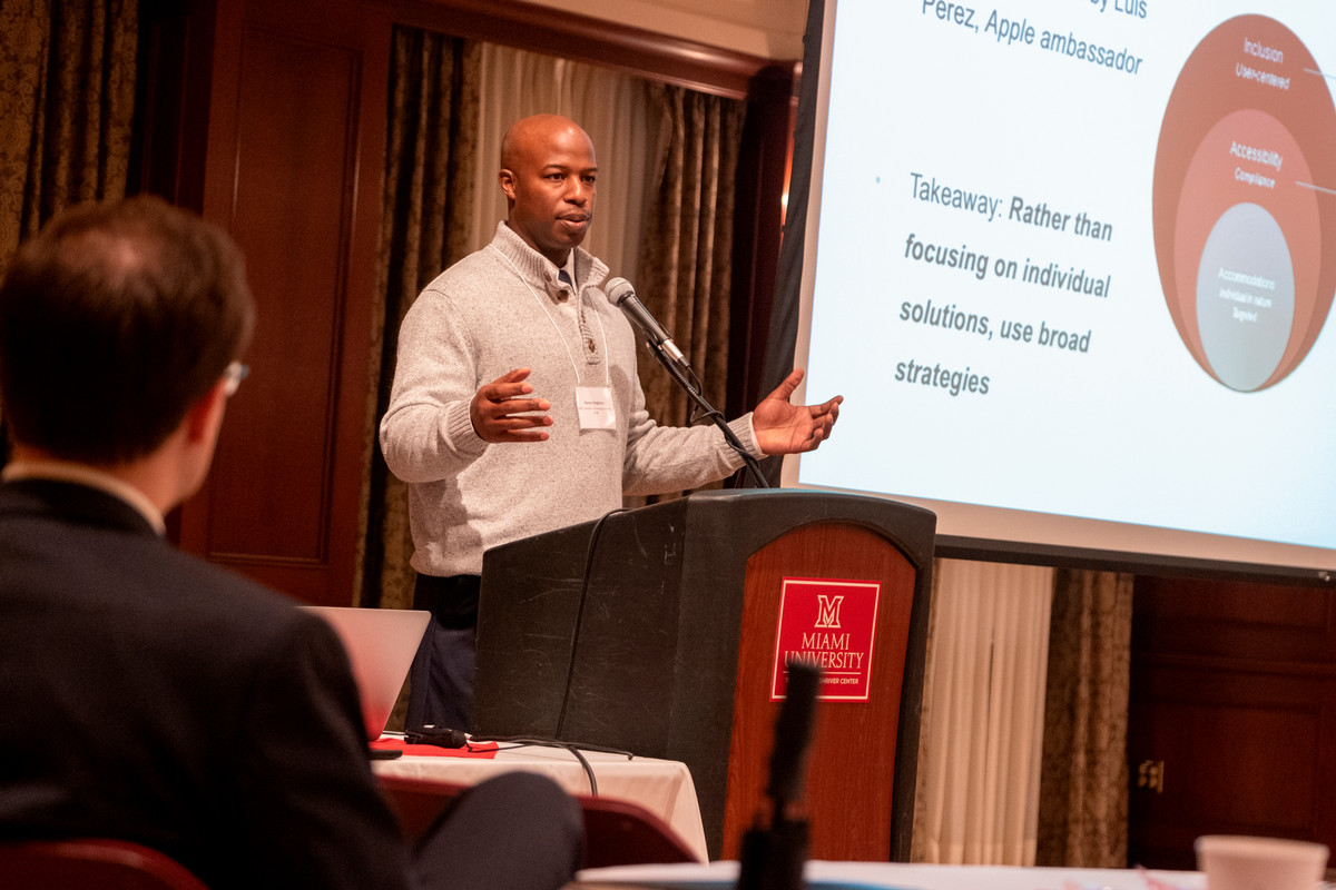 Access for All keynotoe speaker in 2019, a man standing at a podium expressing something with his hands