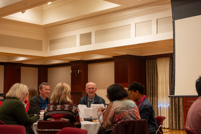 Attendees smile and chat at luncheon