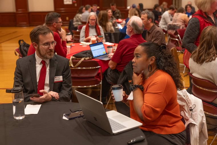 David and Belinda chat at a table