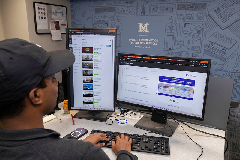 A student intern works on a captioning project