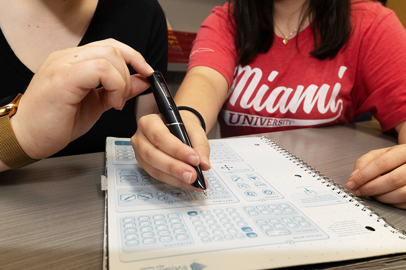 A person using a livescribe smart pen