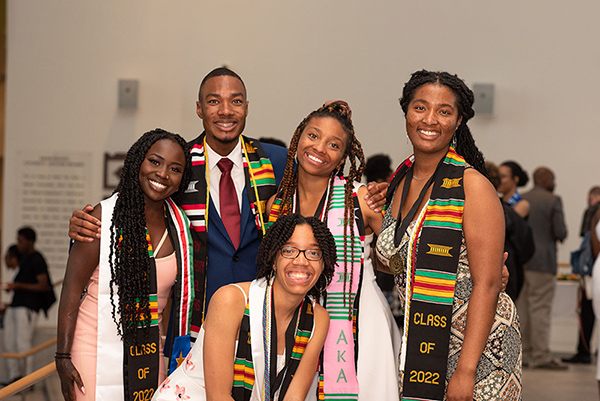 A group of Black students wearing cultural regalia at commencement