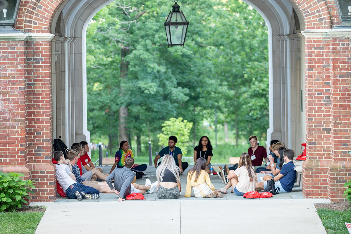 students sitting in a circle outside