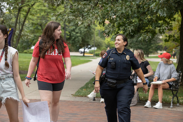 Student walks on the Oxford campus with Officer Nicole Roberts