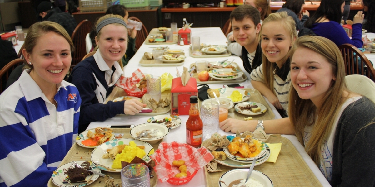 students eating lunch in a dining hall