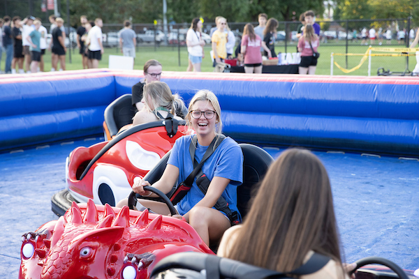 Students riding on bumper cars at an on-campus event