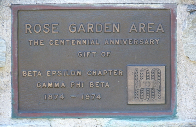 Plaque that reads Rose Garden Area The centennial anniversary gift of Beta Epsilon Chapter Gamma Phi Beta. 1874-1974.