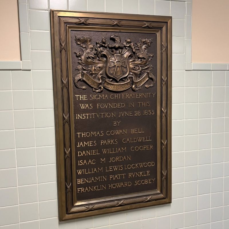 Plaque that reads The Sigma Chi Fraternity was founded in this institution June 28, 1855 by Thomas Cowan Bell, James Parks Caldwell, Daniel William Cooper, Isaac M Jordan, William Lewis Lockwood, Benjamin Piatt Runkle, Franklin Howard Scobey.
