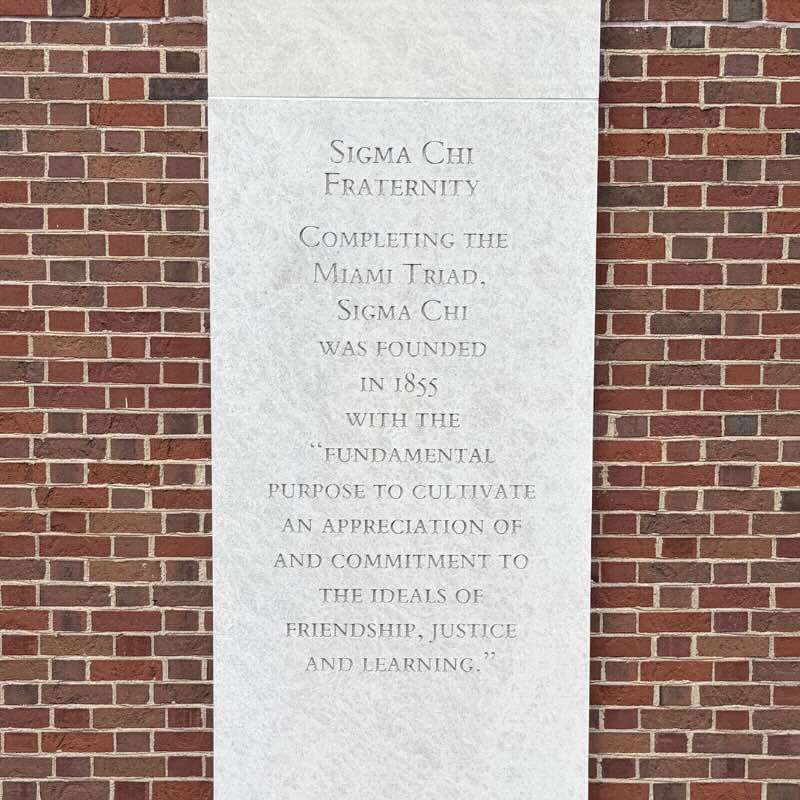 Concrete column with words etched: Sigma Chi Fraternity. Completing the Miami Triad, Sigma Chi was founded in 1855 with the "fundamental purpose to cultivate an appreciation of and commitment to the ideals of friendship, justice, and learning."