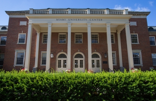 Exterior view of the front of Shriver Center, red brick building with tall tan columns.