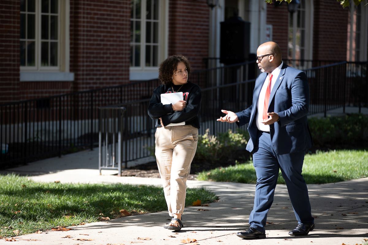 Nyah Smith walking on campus while talking with the Dean of Student BaShaun Smith