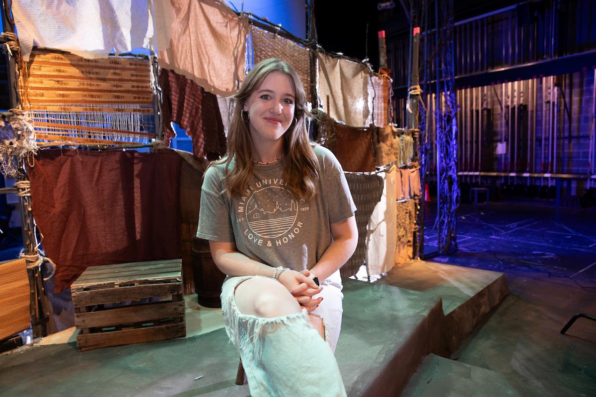 Tammy Sanow sitting on a theater stage