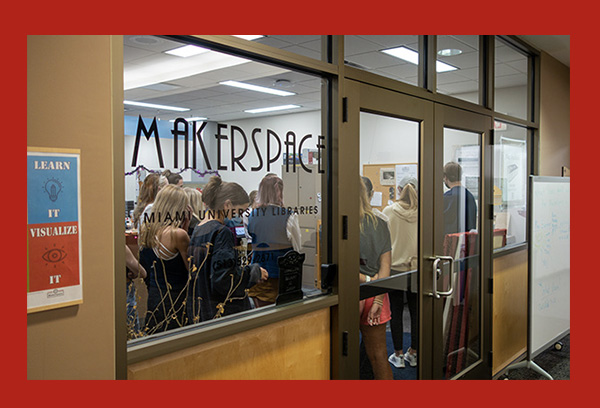 a group of students viewed through the window of the MakerSpace