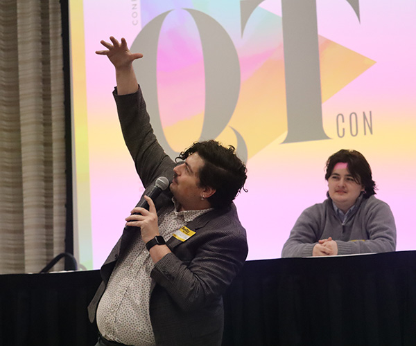 Dylan Carter, who is pursuing a master's degree in Anthropology at the University of Cincinnati, gestures during a presentation on "The New Lens of Normality: An Exploration of Queer Representation in Fair Tales, Revisited." 
