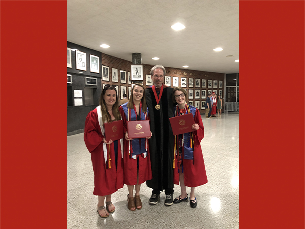 Richard Campbell stands with Megan Zahneis and two other graduates