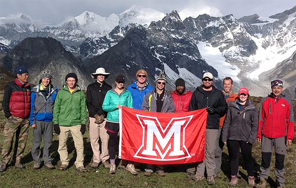 Students in Miami's Life at Altitude faculty-led program pause while hiking in the Himalayas