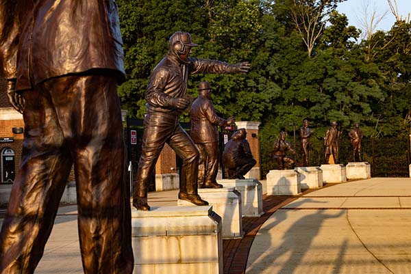 Cradle of Coaches plaze with close up of several bronze coach statues