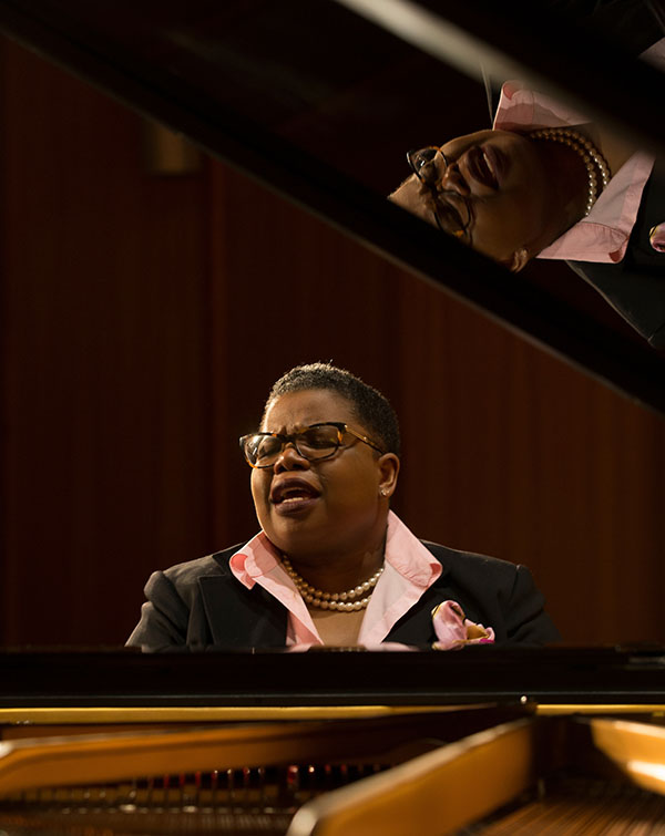 Tammy Kernodle sings at the piano 