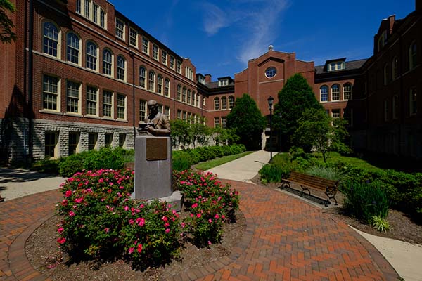 mcguffey hall courtyard with red flowers in foreground