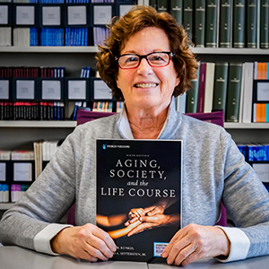 Dr. Suzanne Kunkel with her book 'Aging, Society, and the Life Course'