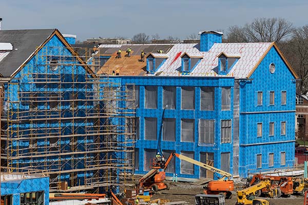 Construction workers on the roof of the north wing of CHSW facility 