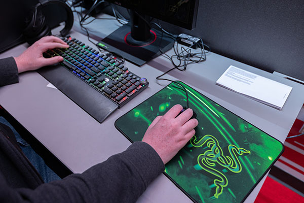 someone's hands on a gaming keyboard