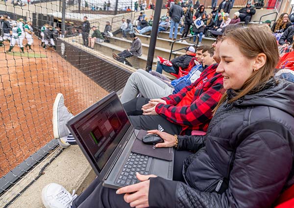 Caroline Brega watches softball game