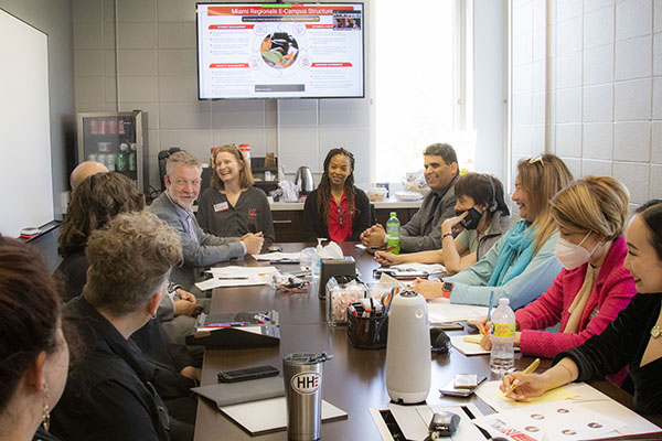 E-regionals staff and IVLP visitors talk in a conference room