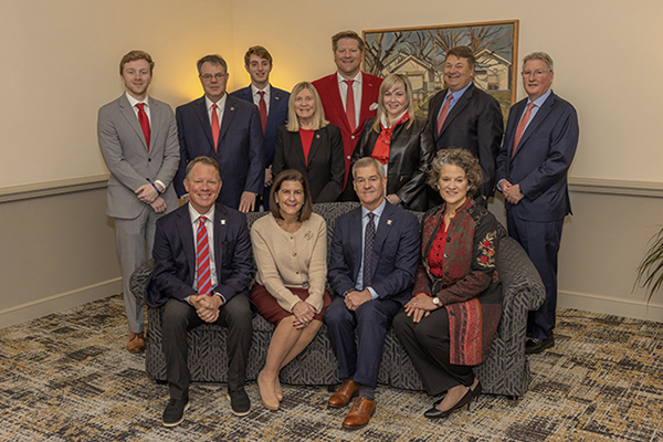 Dawson Cosgrove, top left, standsbeside members of the Miami University Board of Trustees