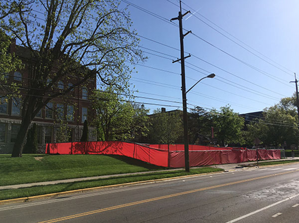 A red construction fence perpendicular to King Library, with sign Welcome Back