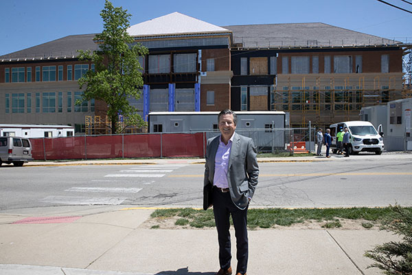 Rick McVey stands in front of McVey Data Science under construction