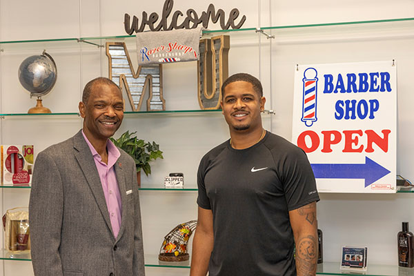 Mark Taylor and Marquan Richardson in the Razor Sharp barbershop located in Armstrong Student Center