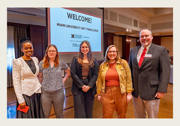 Mike Crowder (right), dean of the Graduate School, congratulates the winners of Miami's Three Minute Thesis competition. Left to right: Tochukwu Nwoko, Autumn Otto, Jessica Flower, and Kathryn Aldstadt (photo by Scott Kissell)