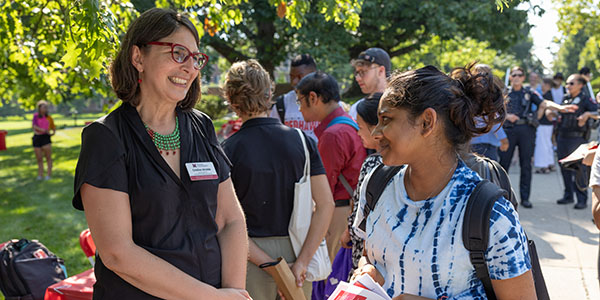 Cristina Alcalde, vice president of the Office of Transformational and Inclusive Excellence, interacts with students while on Miami University's Oxford campus.