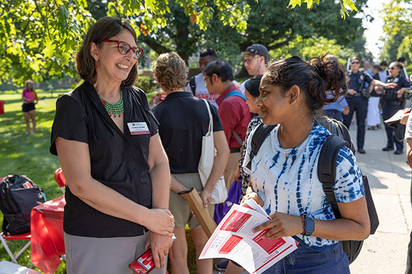 Cristina Alcalde, vice president of the Office of Transformational and Inclusive Excellence, interacts with students while on Miami University's Oxford campus.
