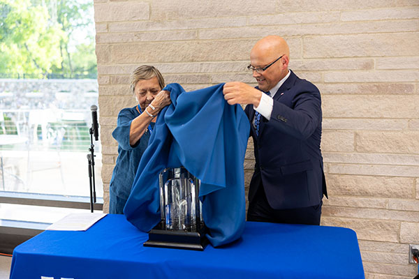 Ann Walton, left, president of the Western College Alumnae Association Board of Trustees, and Miami University President Gregory Crawford unveil the Freedom Summer of '64 Award during a ceremony on June 7 at Western Dining Commons.