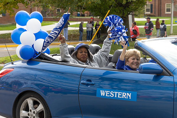 A car representing the Western College Alumnae Association rides in the Homecoming parade in 2023.