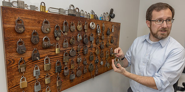 David Seidl, Miami University's vice president for information technology and chief information officer, looks at the collection of locks in his office.