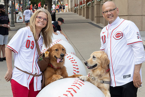  and University Ambassador Dr. Renate Crawford and Miami President Gregory Crawford at Great American Ball Park's Bark in the Park with their dogs, Newton and Ivy