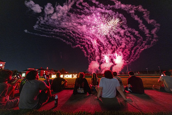 Miami University students watch fireworks behind Benton Hall during Welcome Weekend 2024.