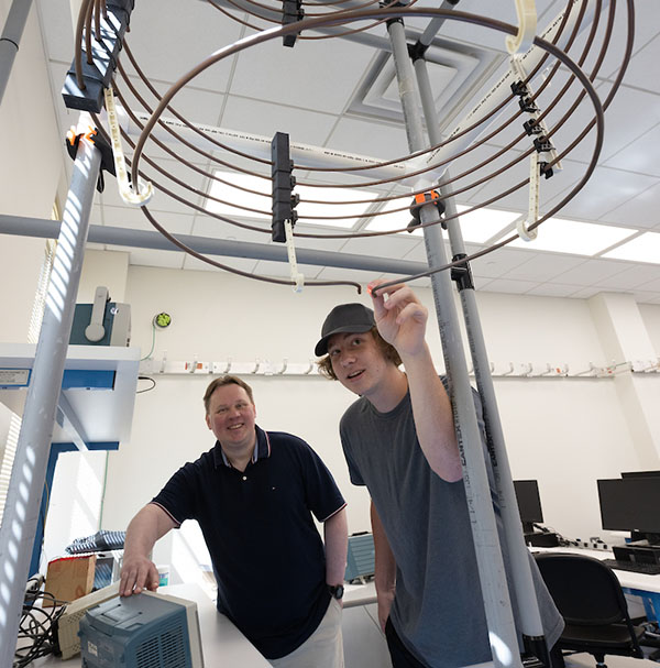 Garmatyuk and student Logan Rauh get ready to demonstrate a wireless electricity experiment in CEC’s electromagnetic lab.