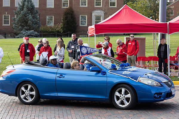 A blue car representing Western College for Women participates in the 2022 Miami University Homecoming Parade