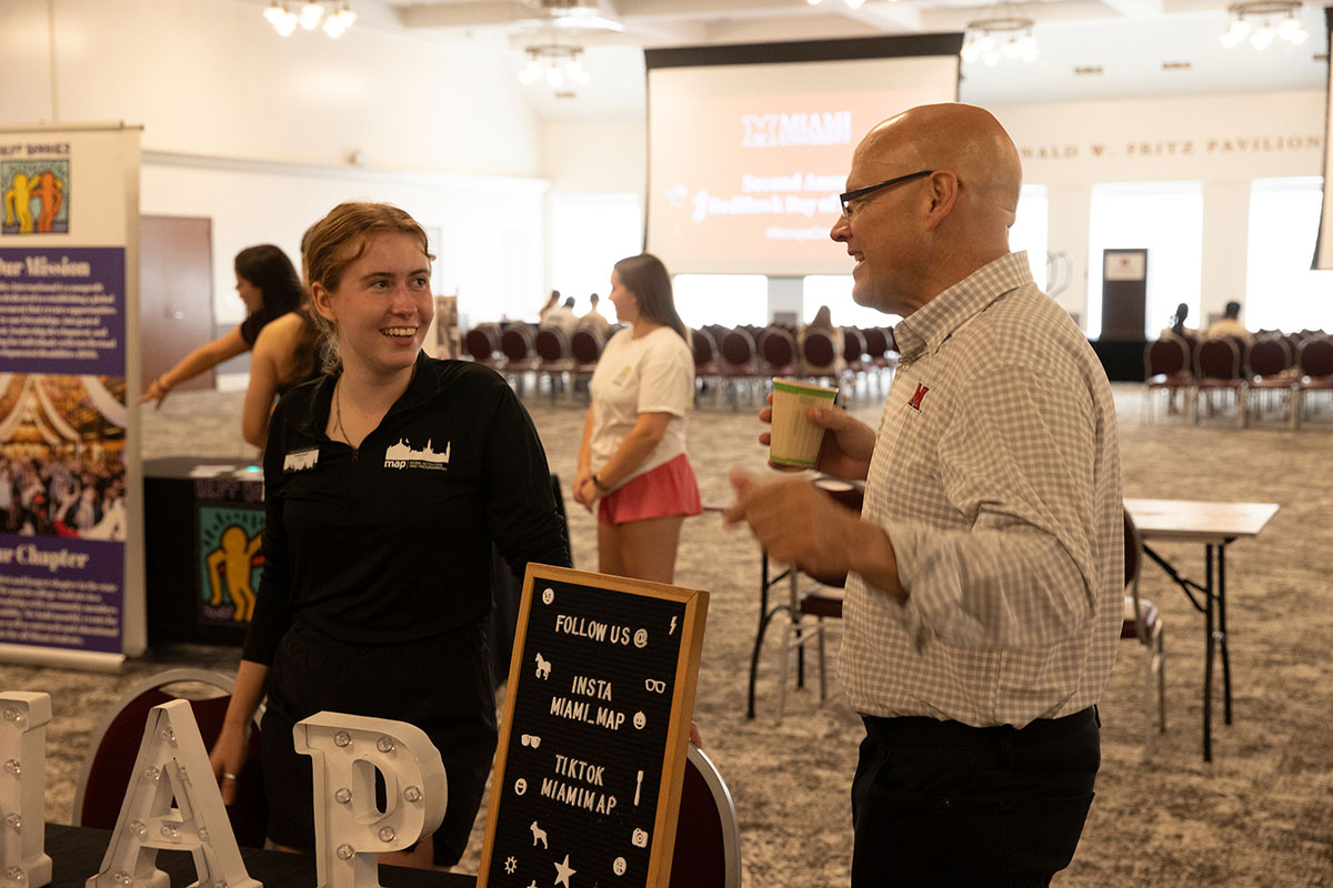 Miami University President Gregory Crawford, right, chats with participants at Armstrong Student Center during the second RedHawk Day of Service on Aug. 31.