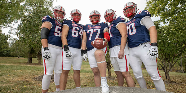 Miami University football players wearing Western College-themed jerseys pose on the Western campus of Miami University.