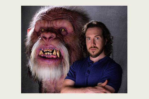 Dan Chudzinski ’07 poses with his sculpture of Bigfoot.
