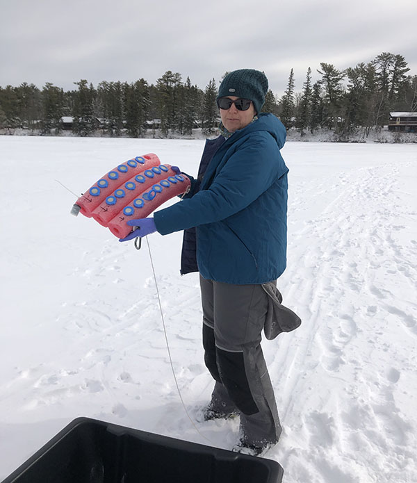 Knoll deploys an experiment in northern Minnesota's Lake Itasca in the winter