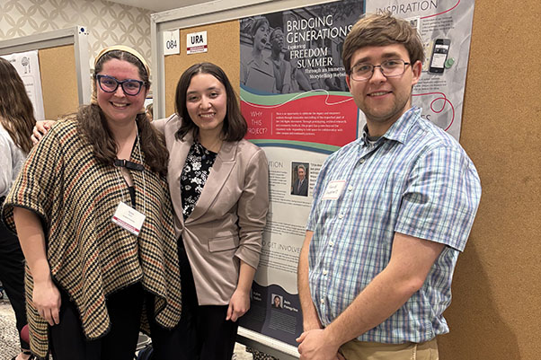 Kylee Halter, Jojo Peregrina, and David Shuppert stand with their poster during the 2025 Undergraduate Research Forum