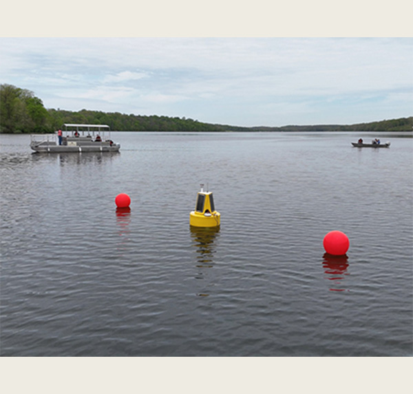 nexsens buoy on Acton Lake with pontoon boat to the left