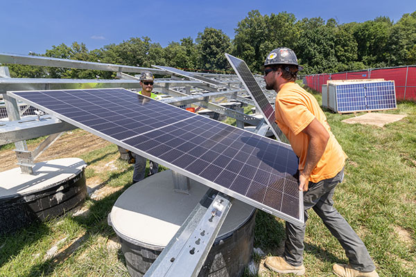A worker installs a solar panel
